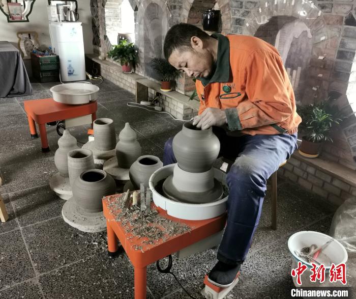梁小板在陶瓷体验馆内忙碌着。　杨杰英 摄